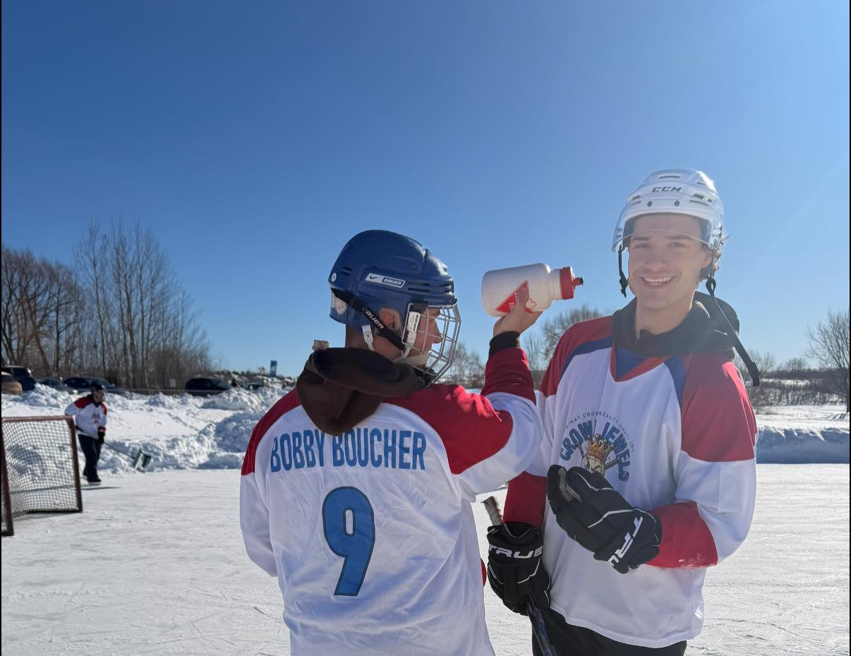 Aleks McTaggart and Shawn Boucher playing pond hockey in Sudbury representing Team KING RE/MAX Crown Realty