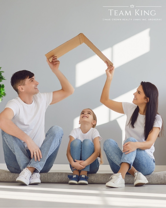 Family of three creating a rooftop with a box in their new Sudbury home, guided by Team KING real estate team
